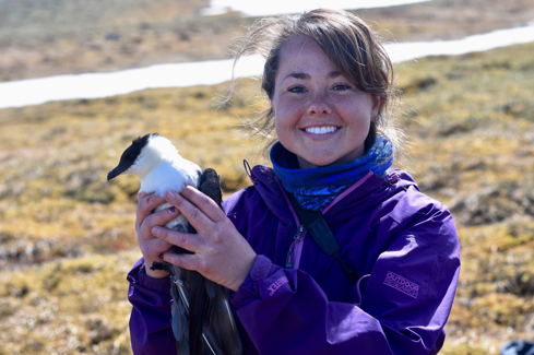 Emily Williams, Avian Ecologist, Denali National Park, holding a Long-tailed Jaeger 